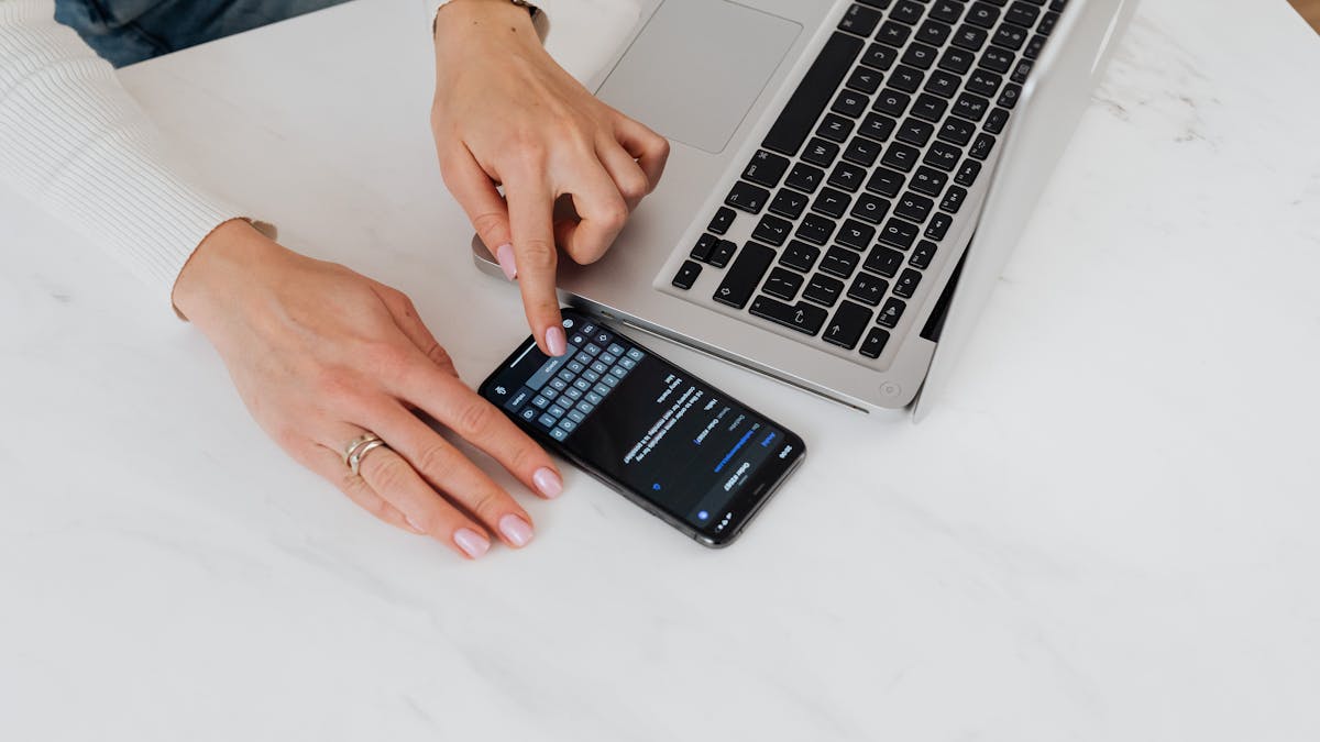 Applying for an online loan in Canada using a phone and laptop