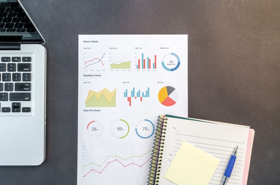 Desk with charts, a laptop, and notebooks comparing best ways to borrow money online in Canada
