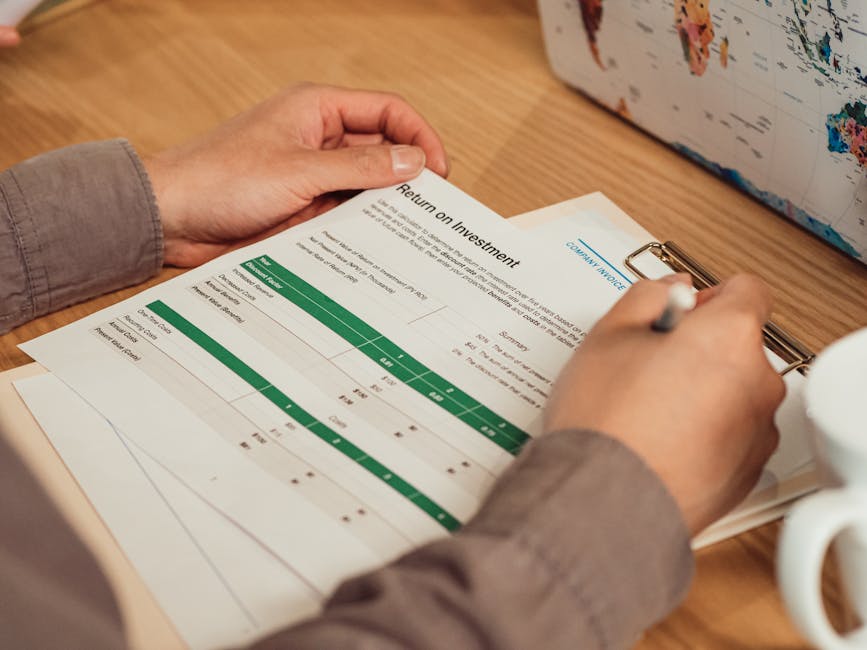 Person reviewing a financial report at a desk, planning $300 loan repayment in Canada