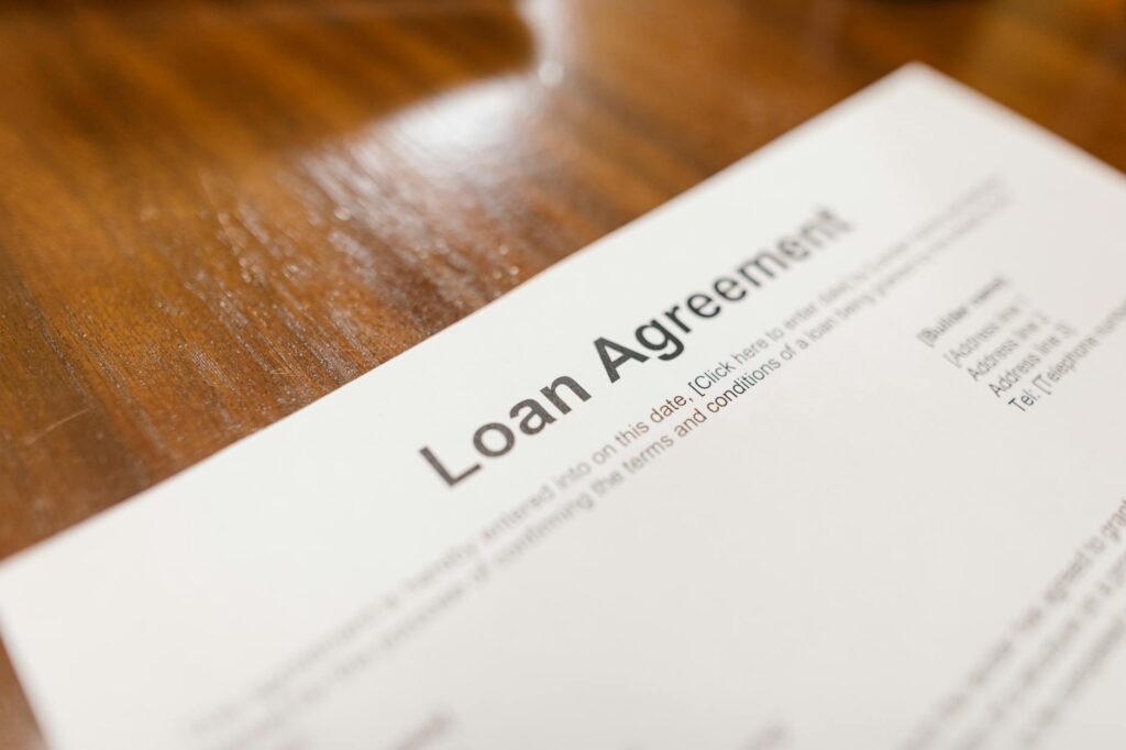 Loan agreement document on a wooden table representing a borrowing application in Canada