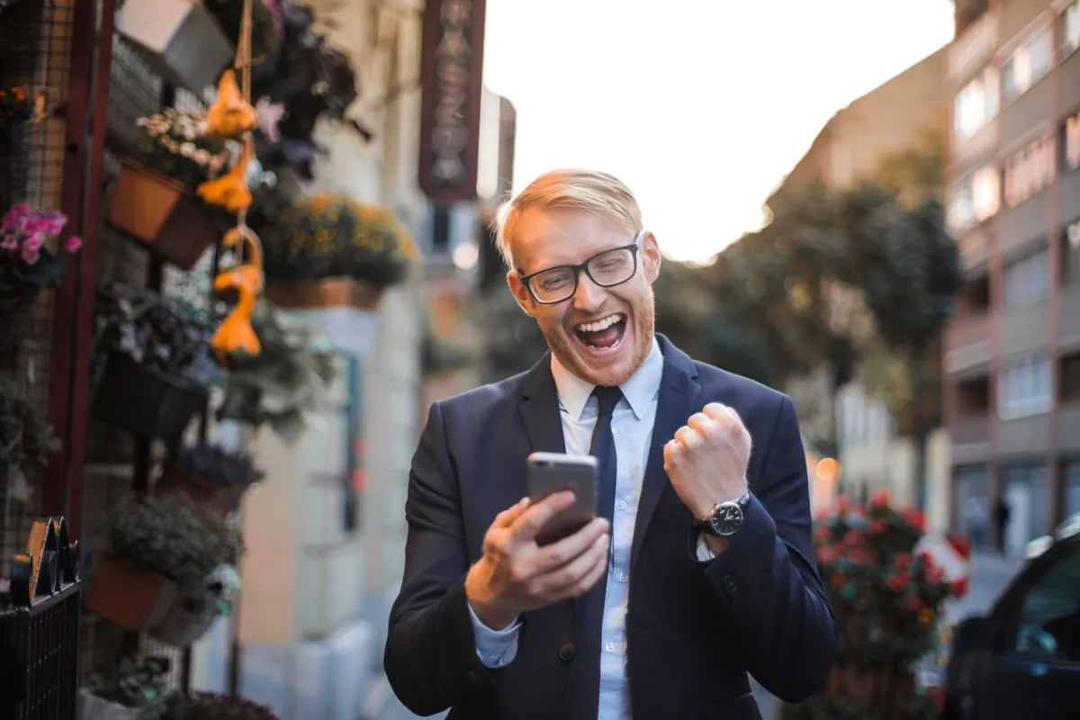 Man celebrating loan approval from a borrow money app in Canada