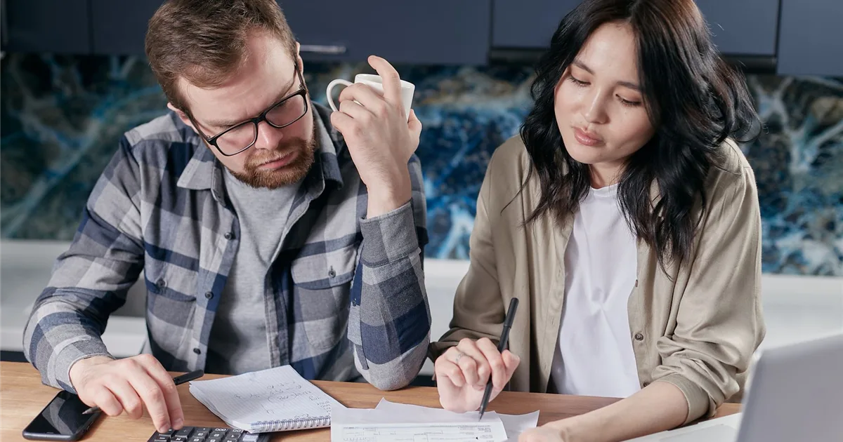 Canadian couple reviewing utility bills before they borrow money for bills