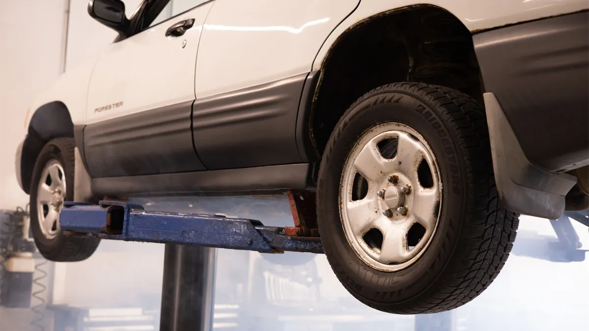Car raised on a garage lift for repairs in Canada