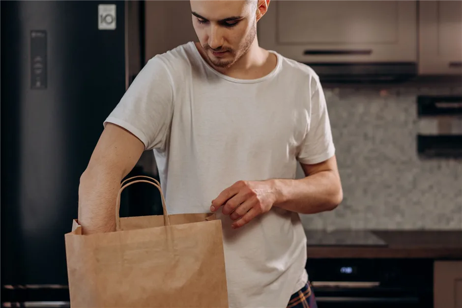 Man bringing home a bag of groceries paid for with a small loan in Canada