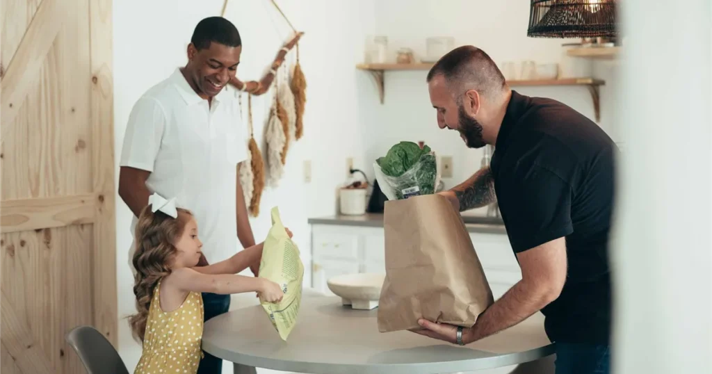Family unpacking groceries at home after using a loan to borrow money for groceries in Canada