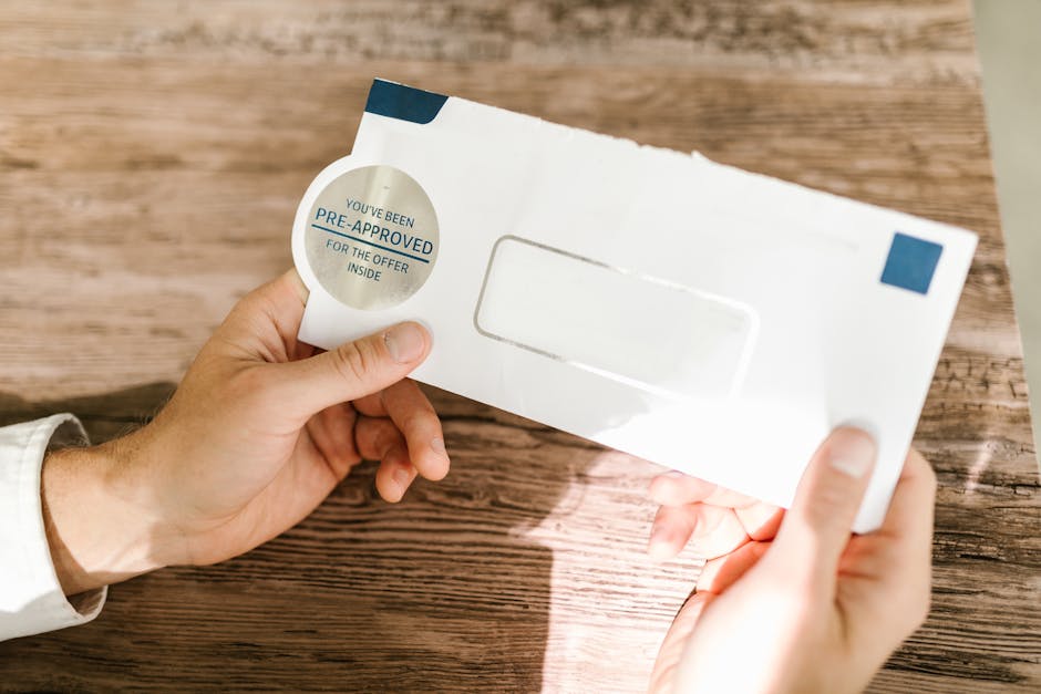 Hands holding a pre-approved loan offer envelope on a wooden table in Canada
