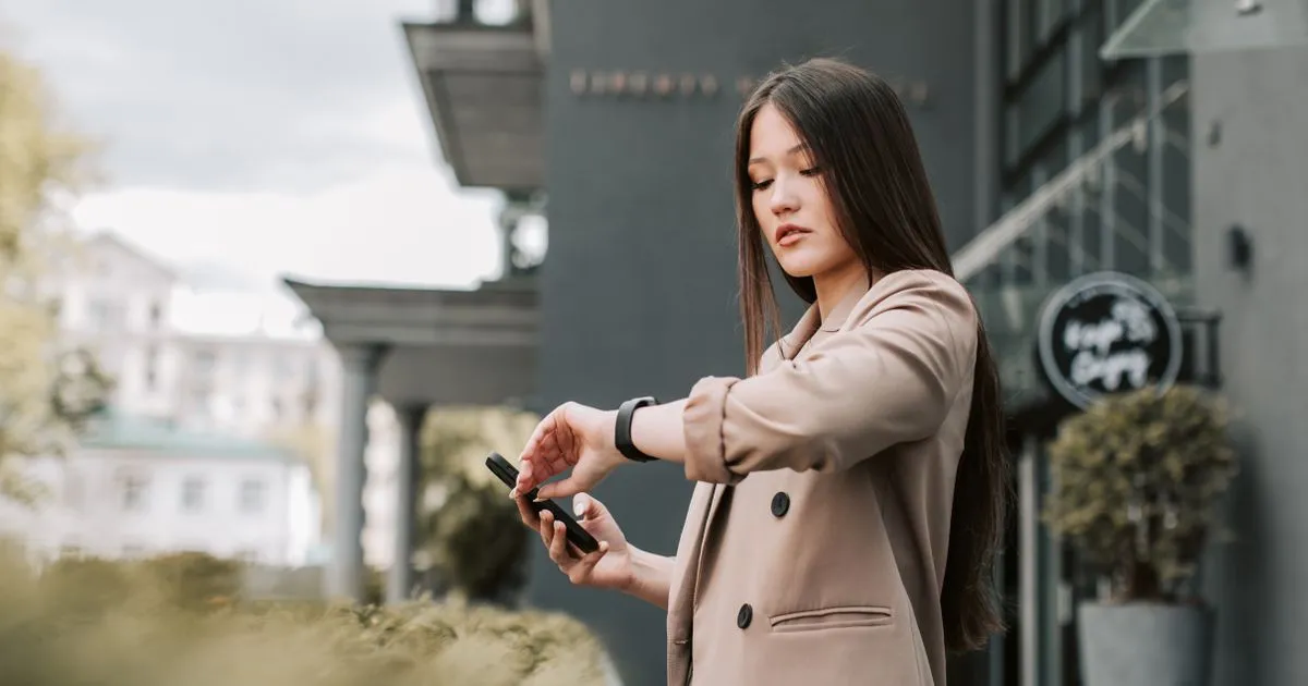 Borrower checking the time on her watch - borrow money online fast in Canada
