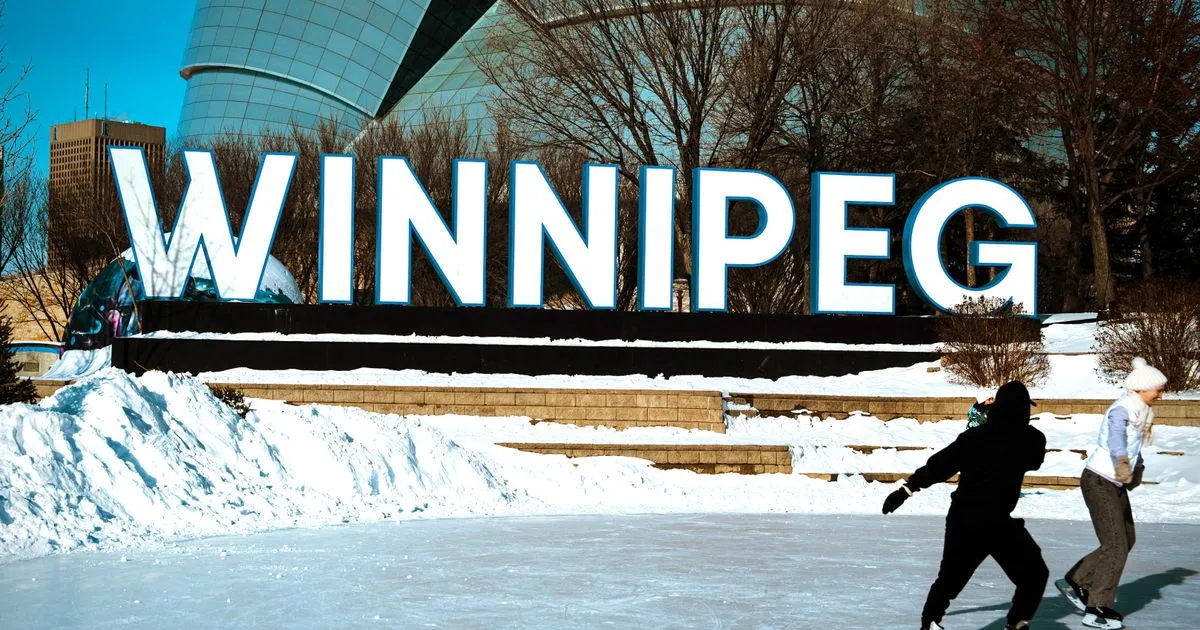 Skaters at the Winnipeg sign at The Forks in winter - borrow money online Manitoba