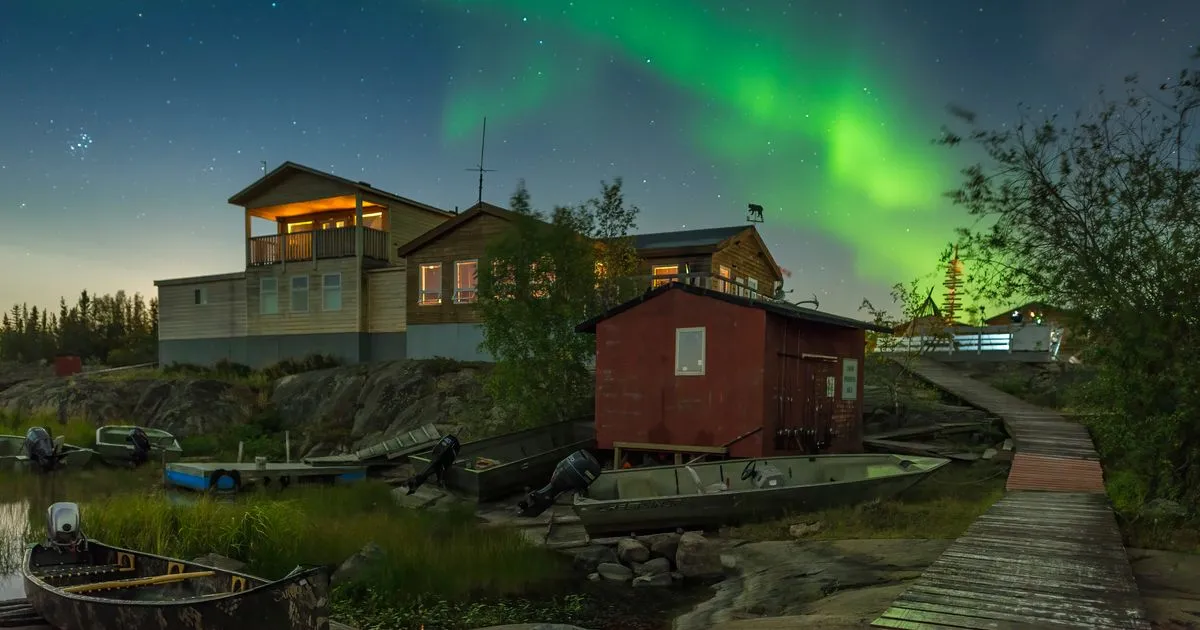 Aurora over lakeside cabins in Yellowknife - borrow money online Northwest Territories
