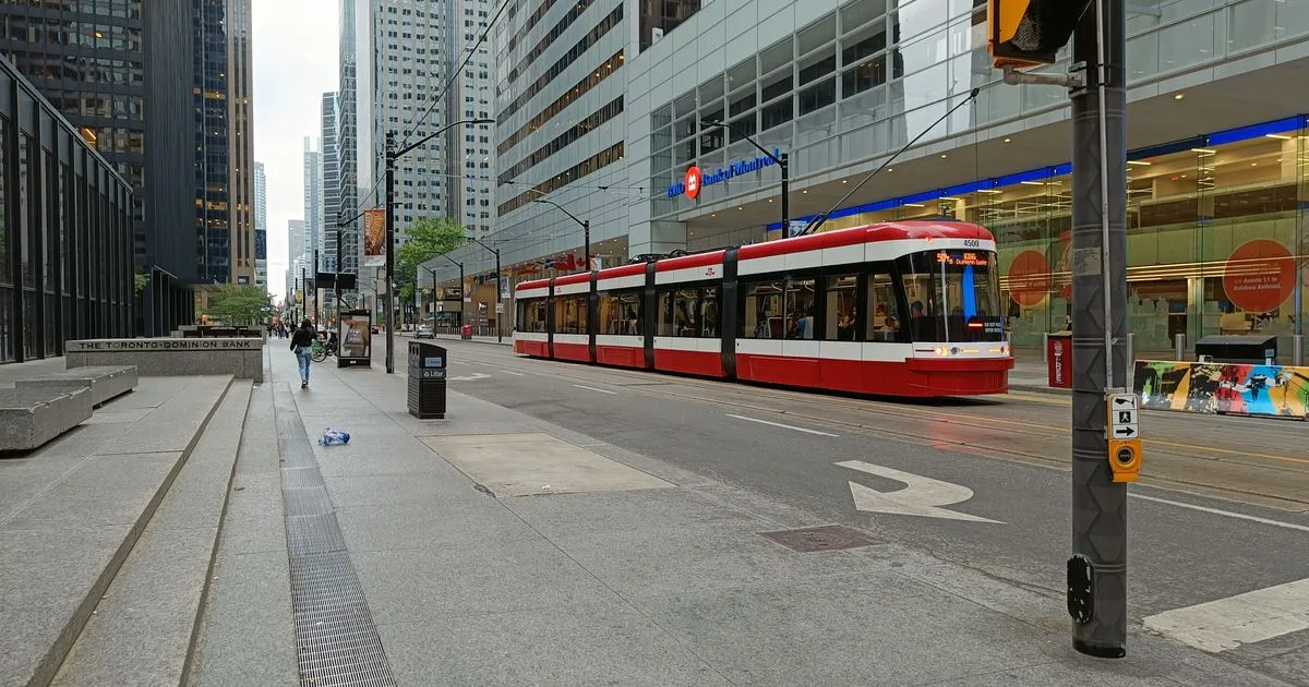 Streetcar passing through Toronto financial district - borrow money online Toronto