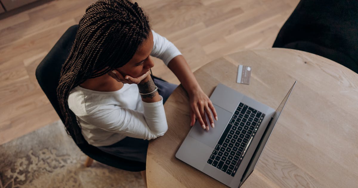 Woman considering a cash advance alternative in Canada on a laptop