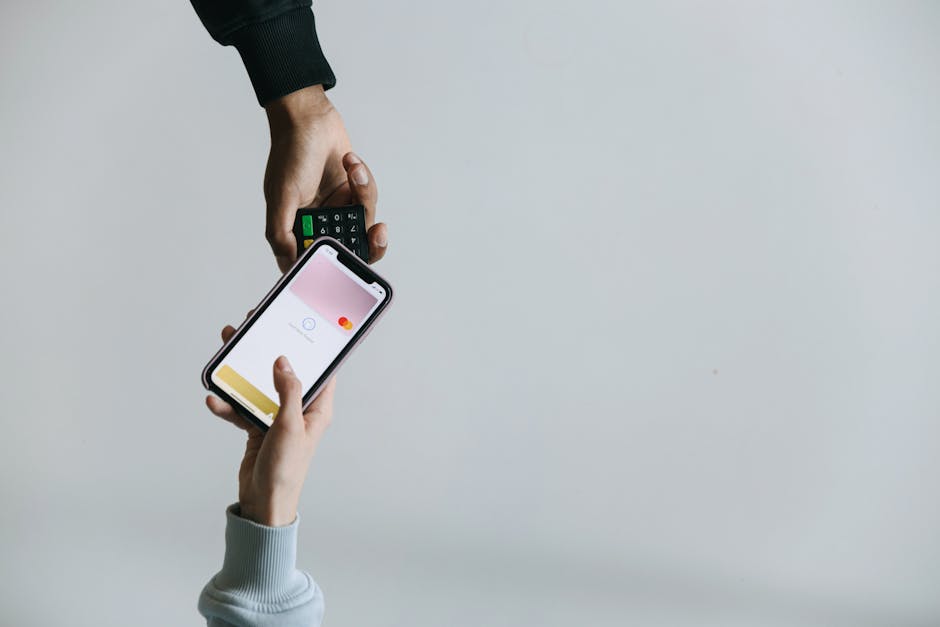 Hands using a smartphone terminal for fast cashless payment in Canada