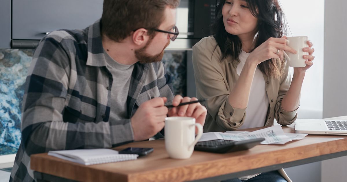 Couple planning repayment of loans with monthly payments in Canada
