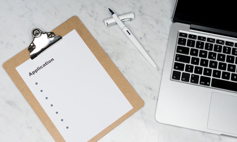 Online loan application form and checklist on a desk in Canada
