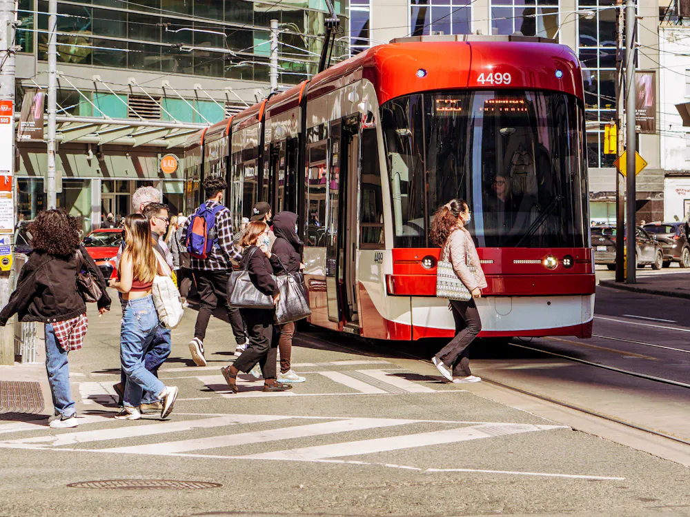 Toronto TTC streetcar and pedestrians downtown - borrow money online Toronto-wide
