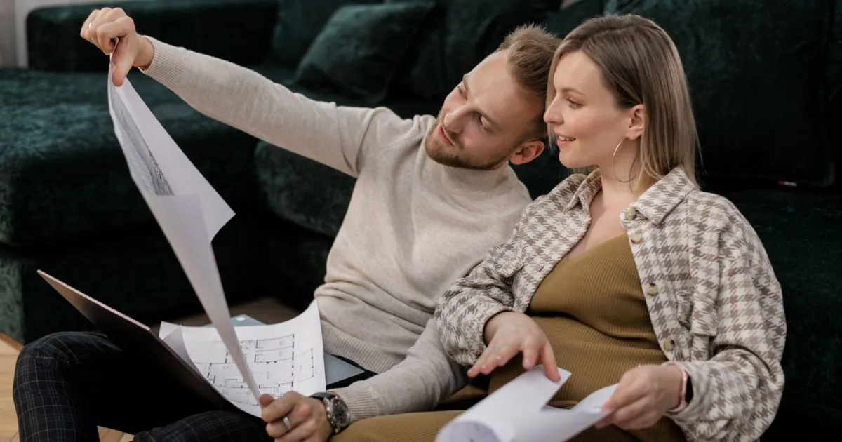 Couple reviewing plans for a $20000 loan project at home in Canada