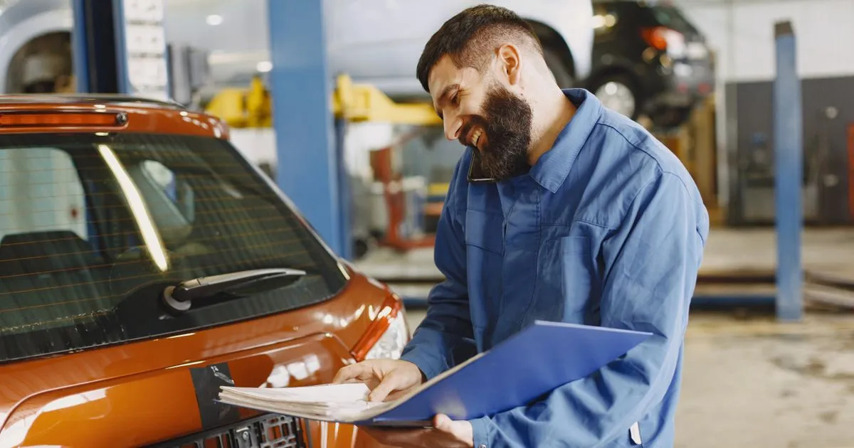 Mechanic reviewing a four-figure repair estimate - a common reason to borrow $1500 online