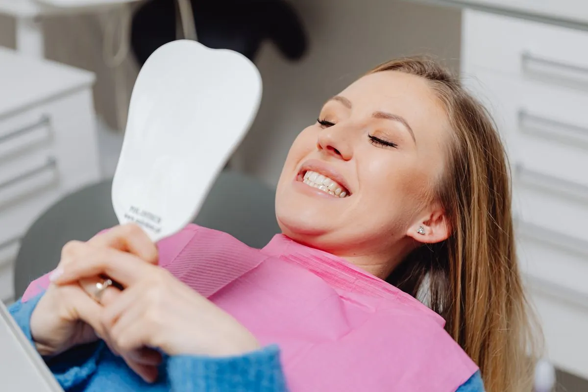 Patient smiling after dental treatment funded by a loan in Canada