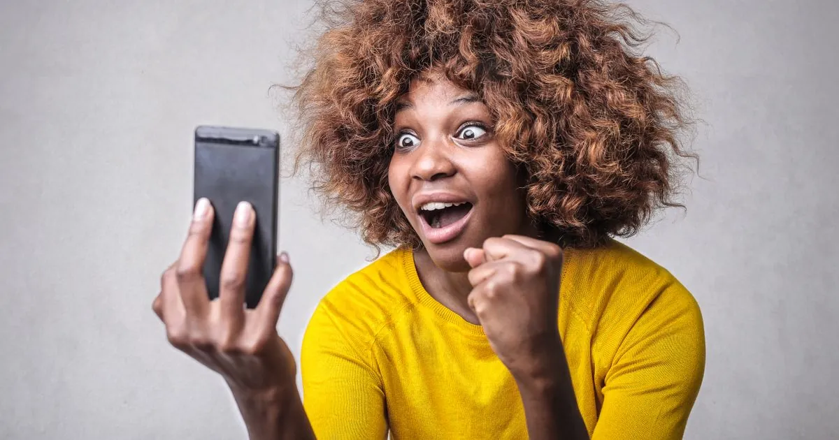 Woman excited by a quick loans decision arriving on her phone