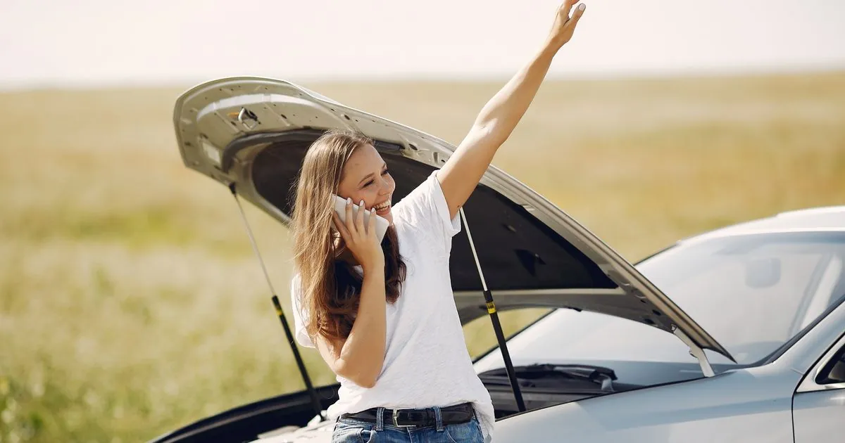 Driver calling for help beside her car, the kind of urgent loans moment that cannot wait