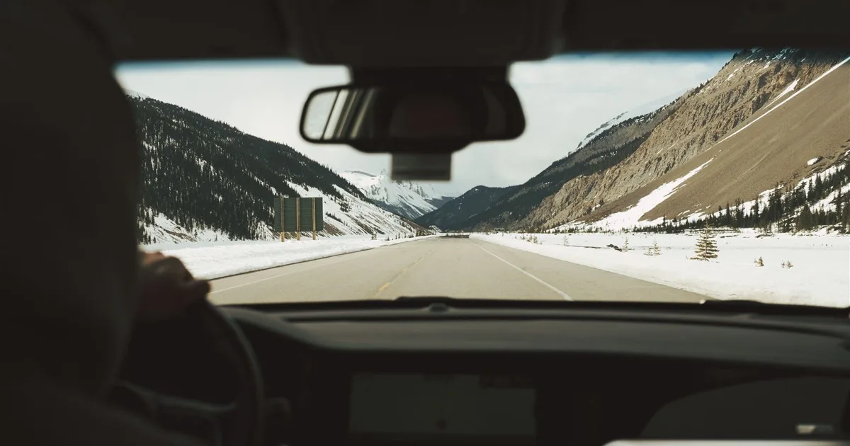 Driving a financed car on a mountain highway in Banff, Alberta
