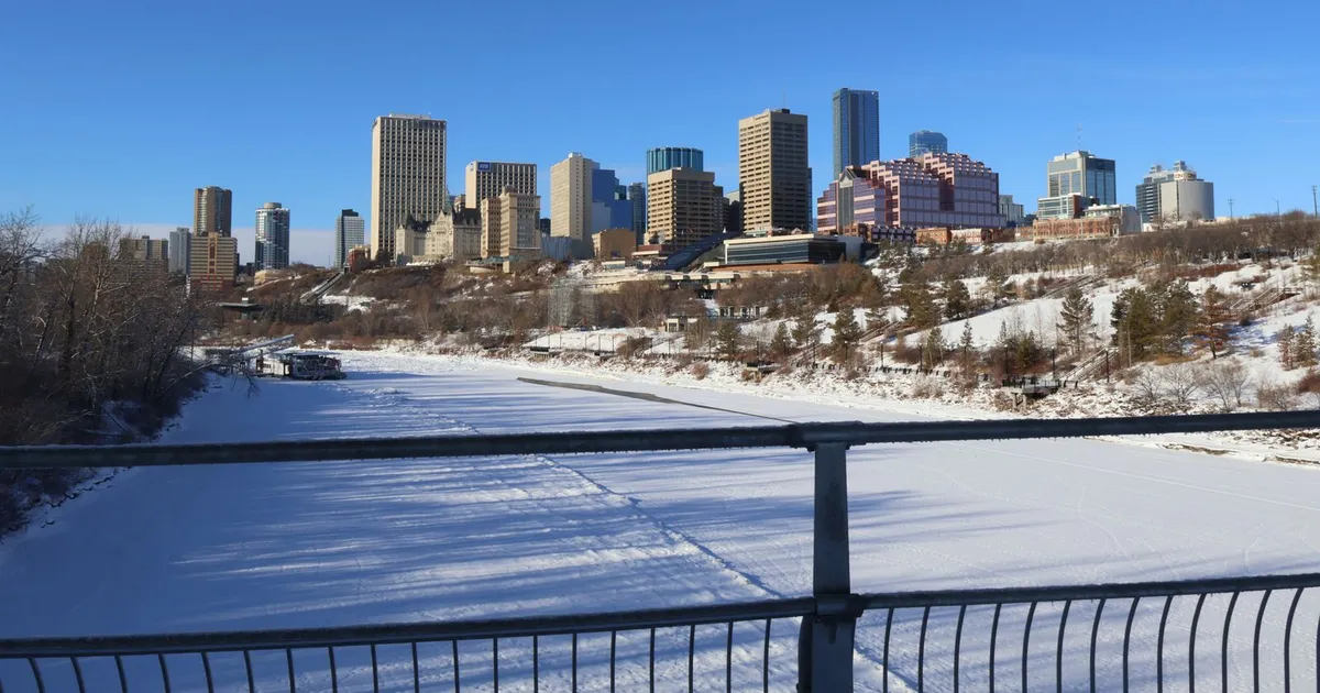 Edmonton skyline over the frozen North Saskatchewan River in winter, when heating bills drive many of the online loans Alberta borrowers take